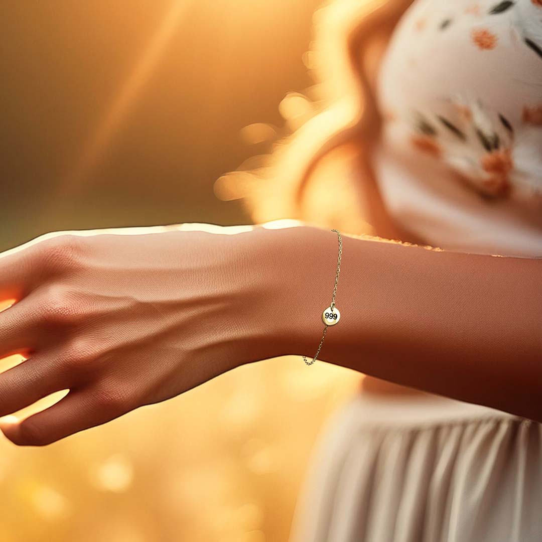 Model hand wearing angel number 999 bracelet gold