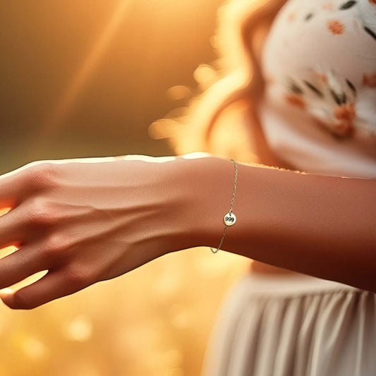 Model hand wearing angel number 999 bracelet gold