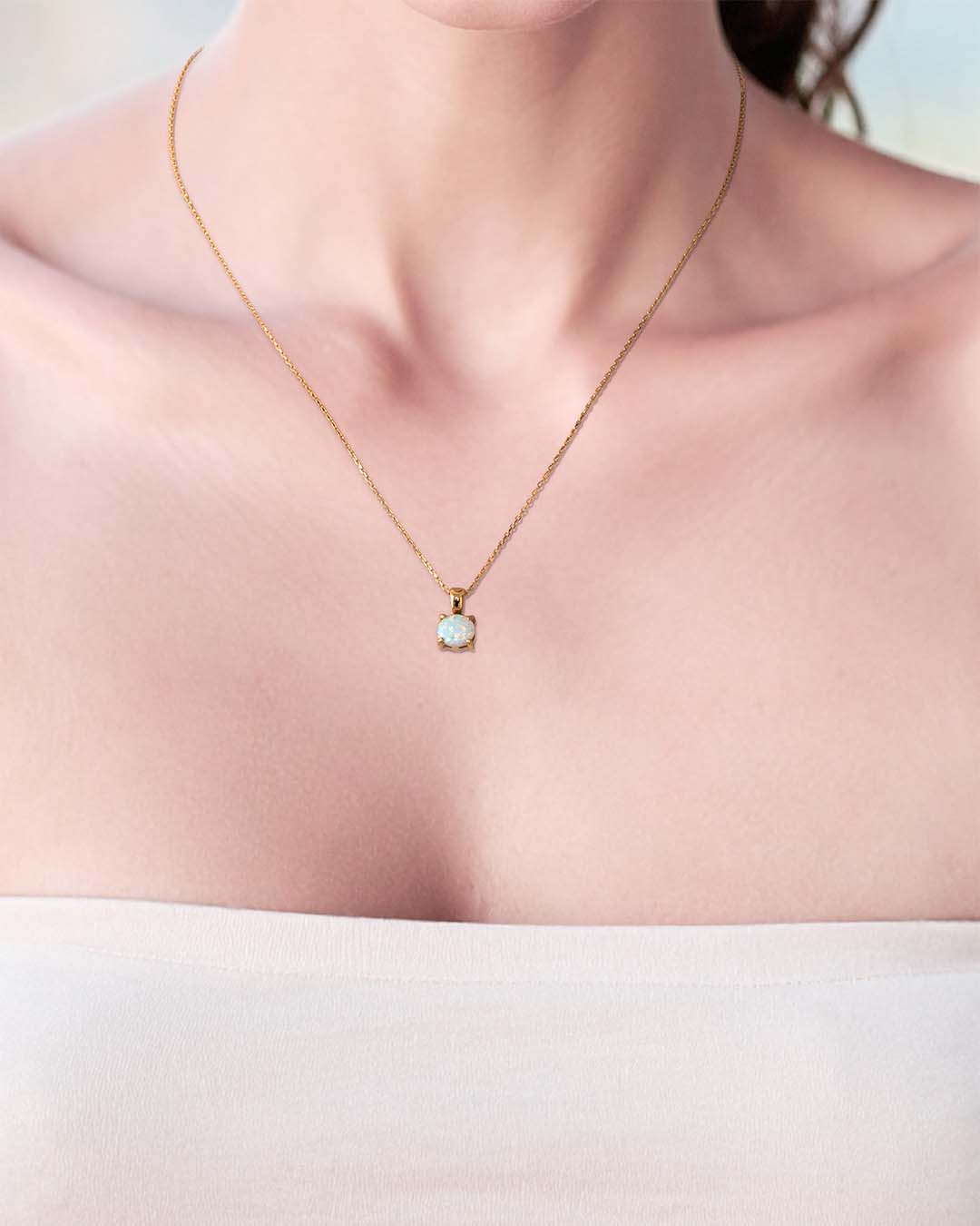 Model wearing Little Lumos Necklace - Gold and Opal closeup