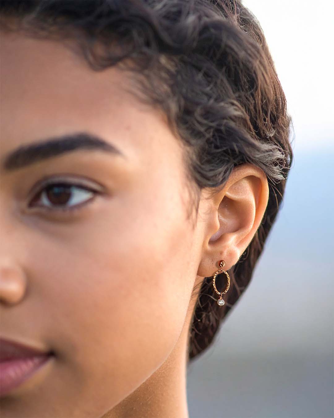 Model wearing Orbit Mini Earrings Gold and Pearl