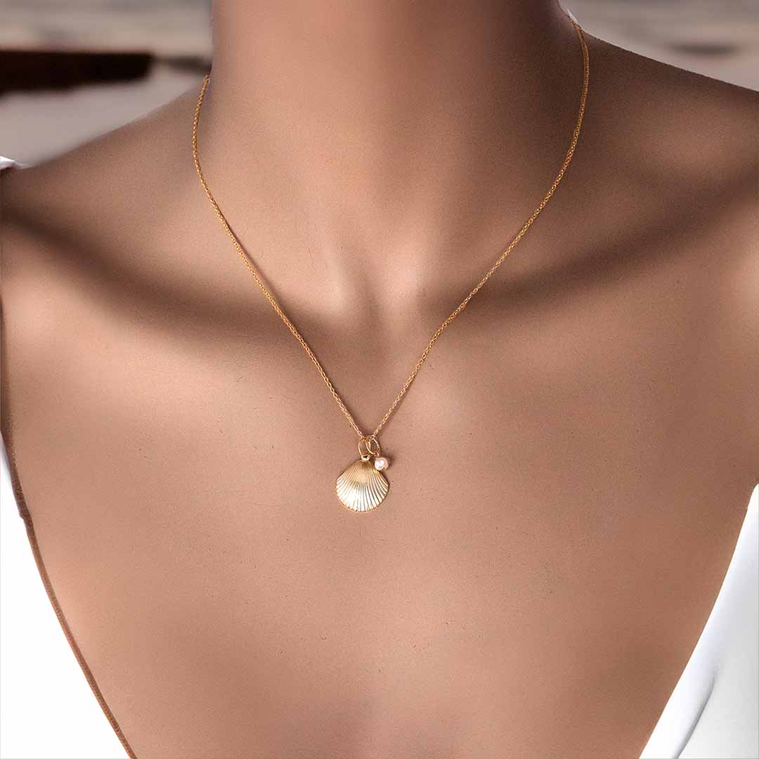 Model wearing Impressions Golden Shell necklace gold pearl