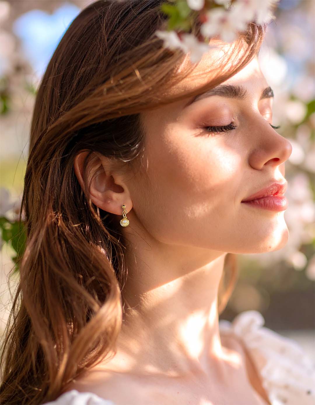 Model wearing Shell Pod Pearl Drop Earrings Gold and Pearl