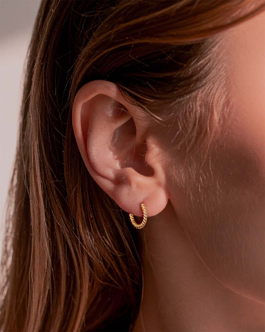 Model wearing Twisted Gold Hoop Earrings 10mm - Gold