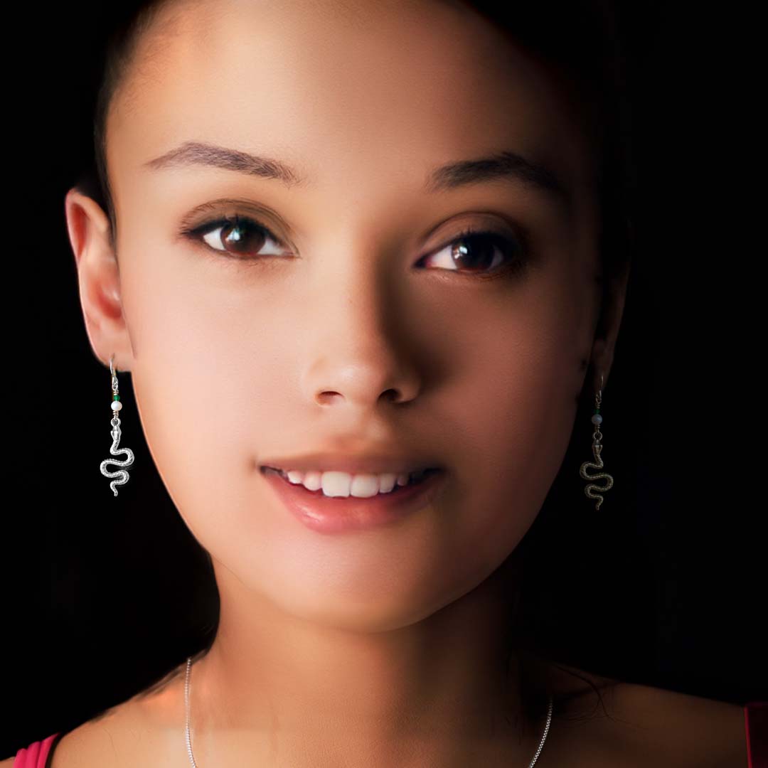 Model wearing Serpent drop earrings silver pearl