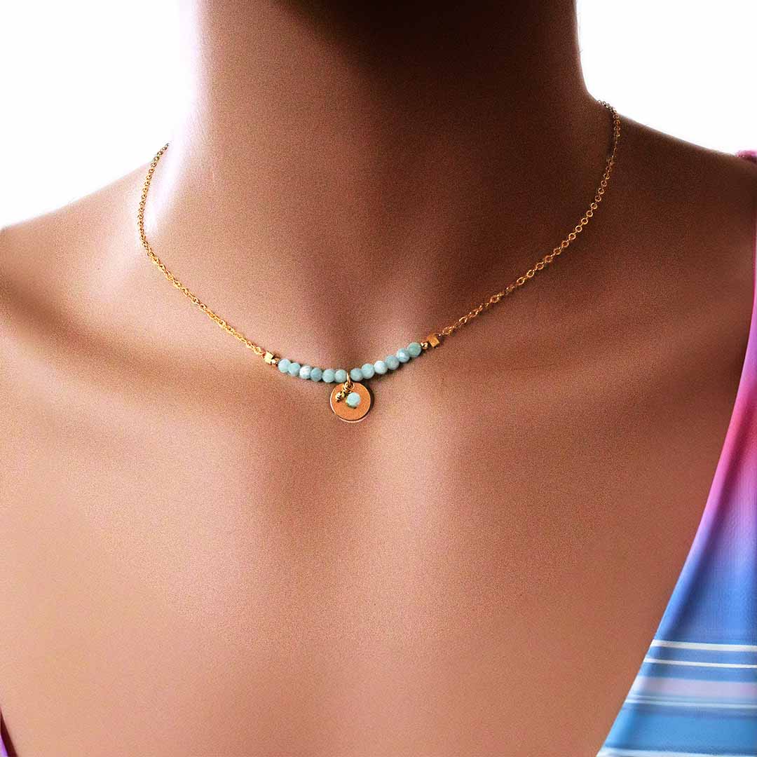 model wearing aura necklace gold aquamarine