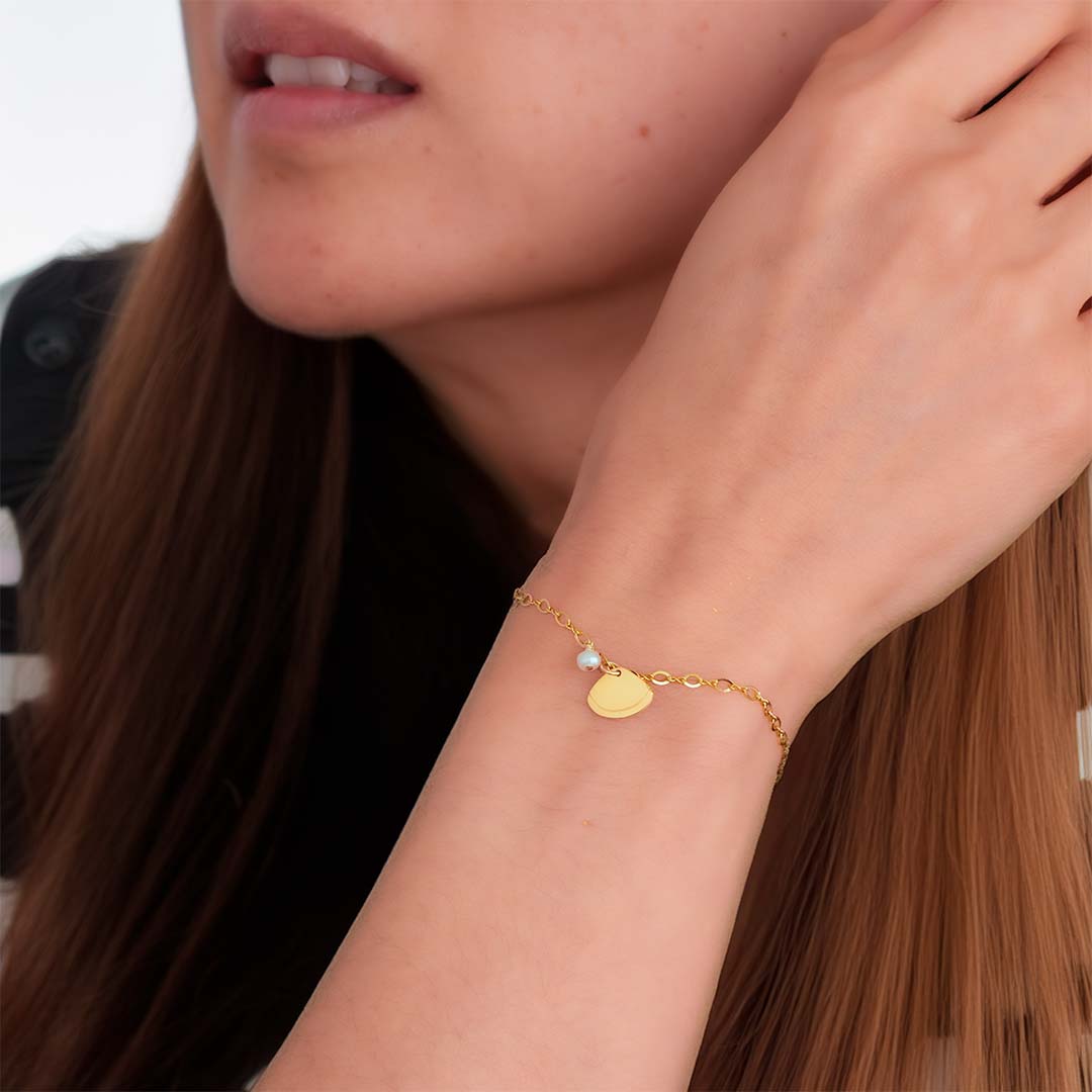 model wearing Clam Shell Bracelet - Gold and Pearl