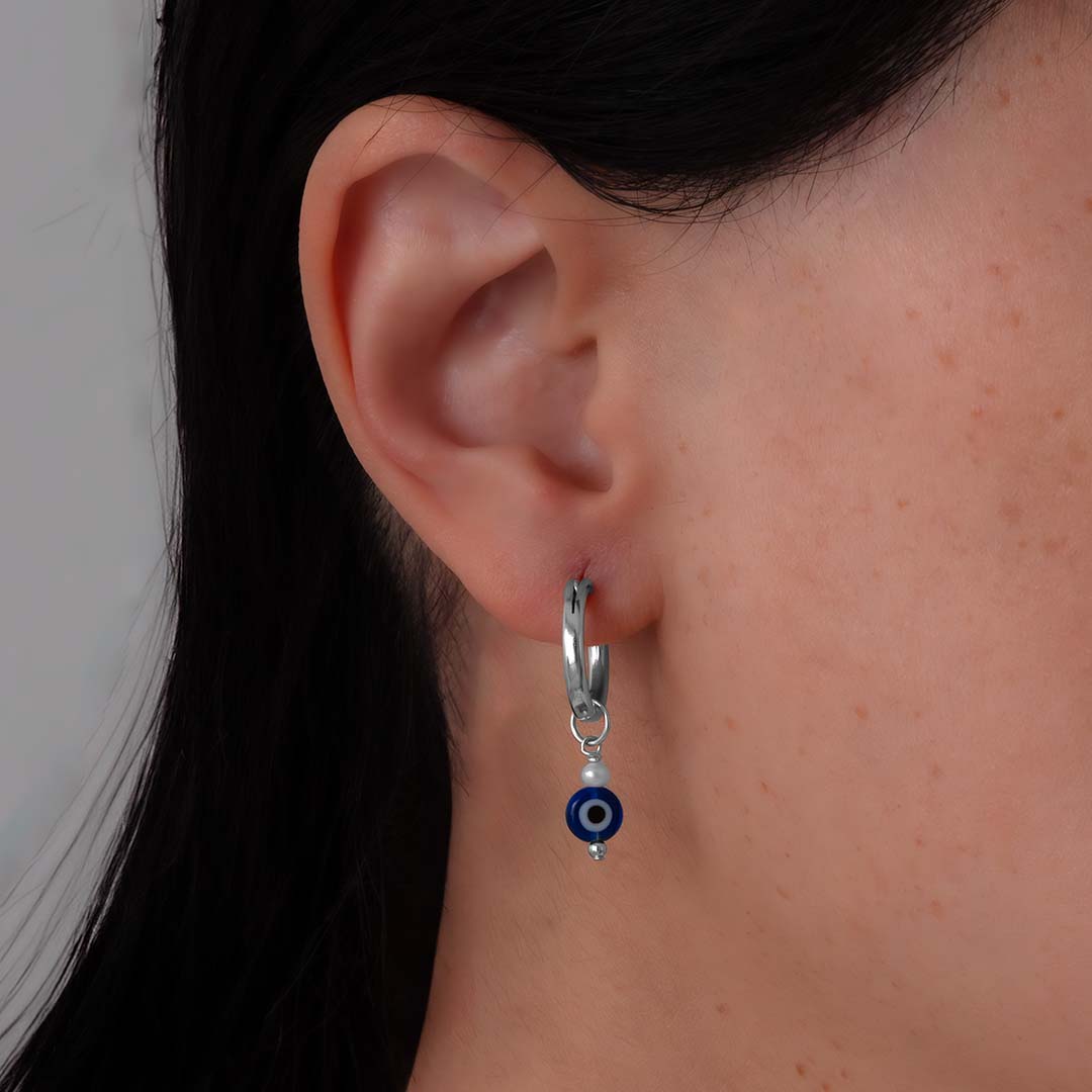 model wearing evil eye charmed hoop earrings silver pearl