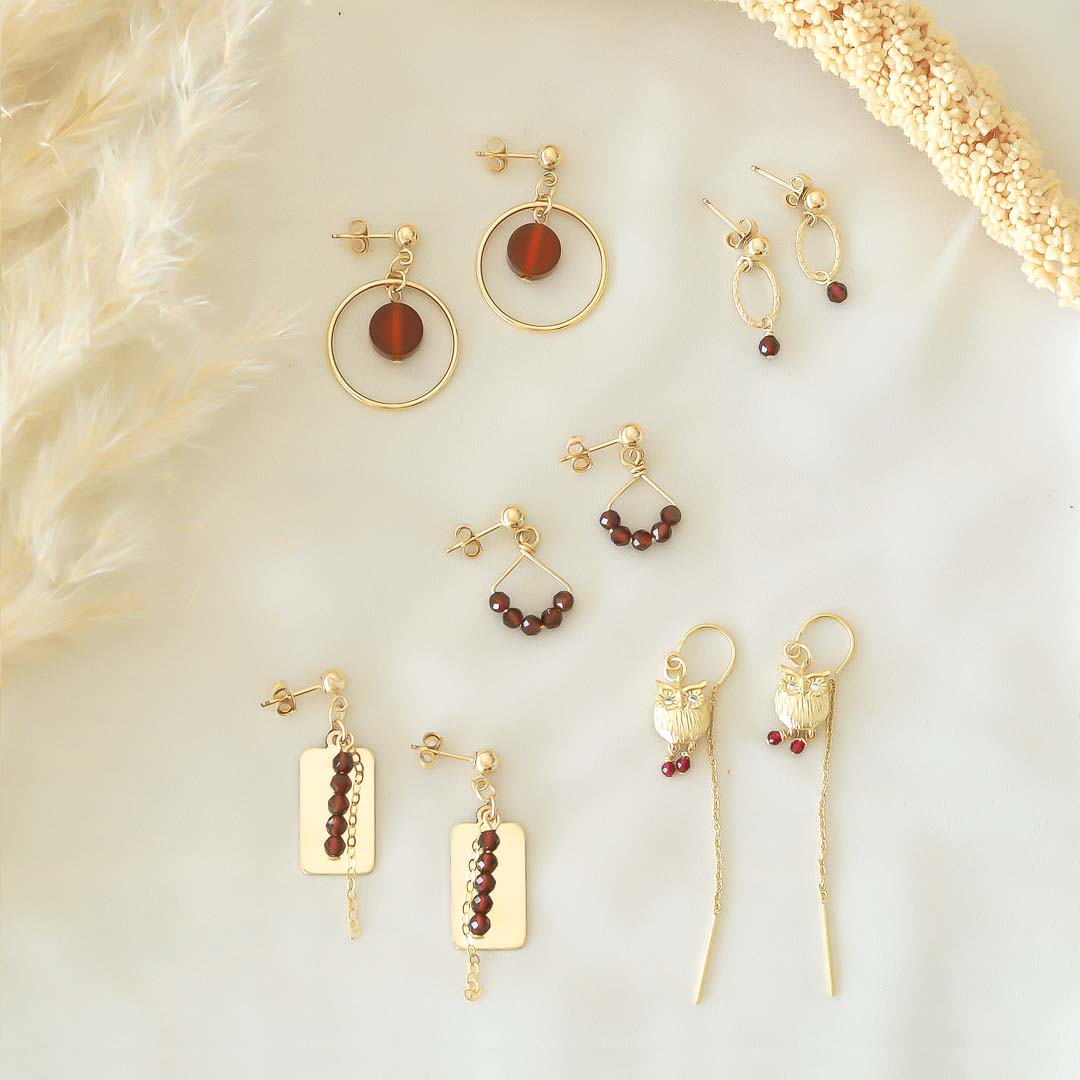 Halo- Angel 5- Reflections- Owl- Orbit earrings in 14K Gold filled with red garnet gemstones flatlay