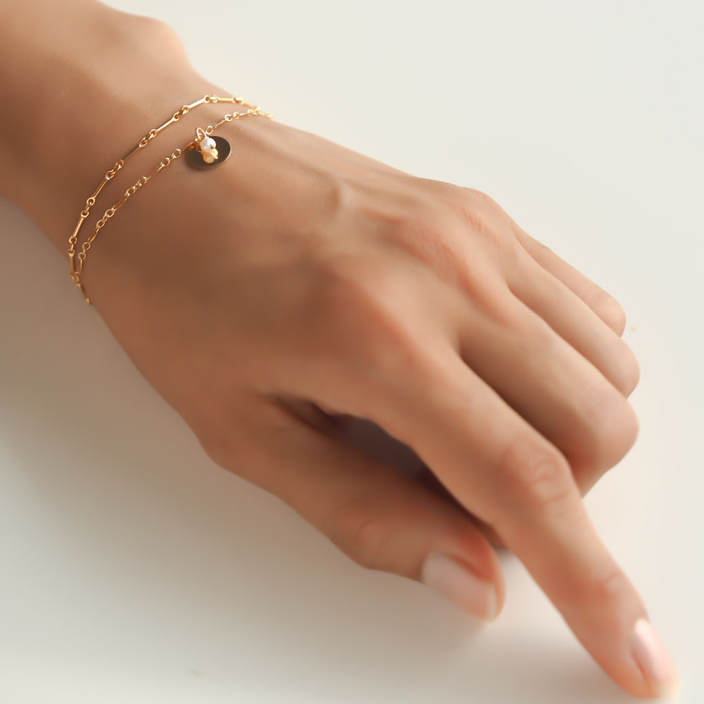 Hand model wearing Unity Bracelet - Gold and Amethyst
