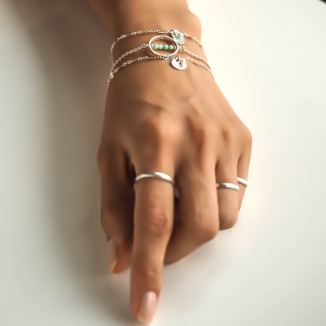 Hand model wearing Halo MOP and Unity Bracelets Silver1