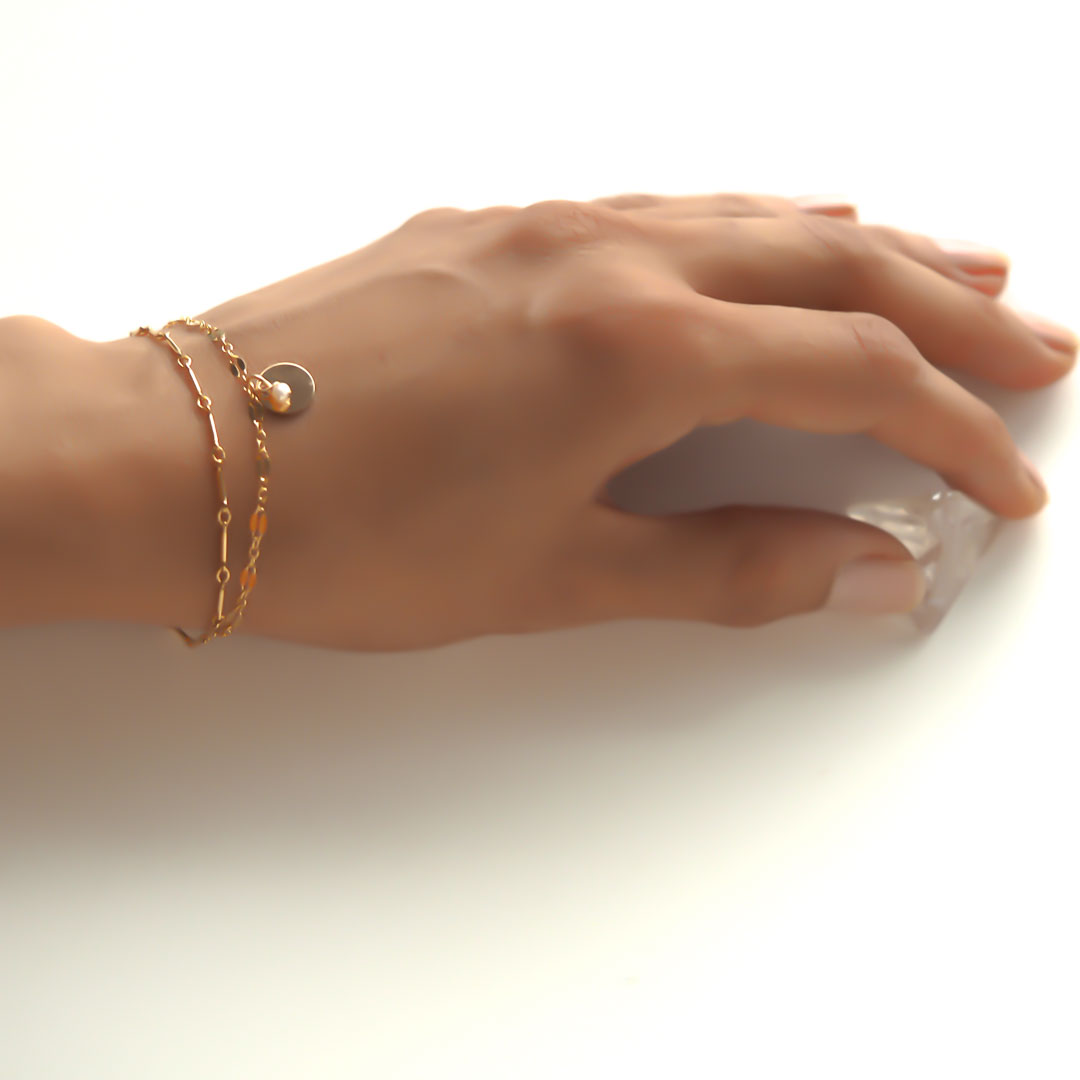 Hand model wearing Unity Bracelet - Gold and Amethyst