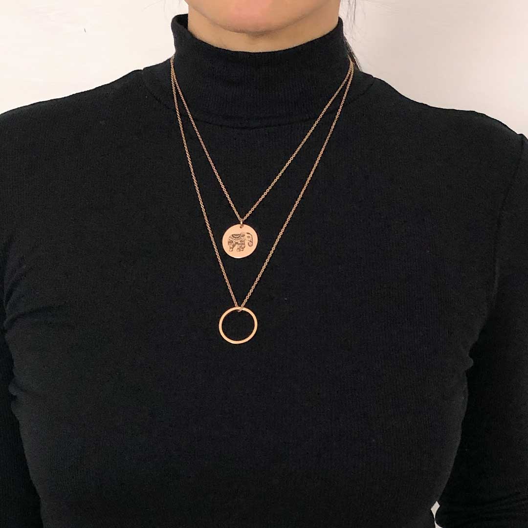Model wearing Ring of fire single and Elephant single Rose Gold