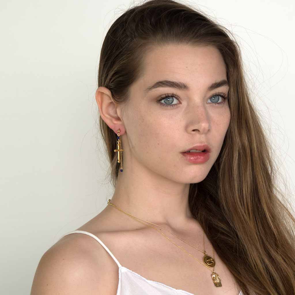 Model wearing Faith Cross Earrings Gold styled
