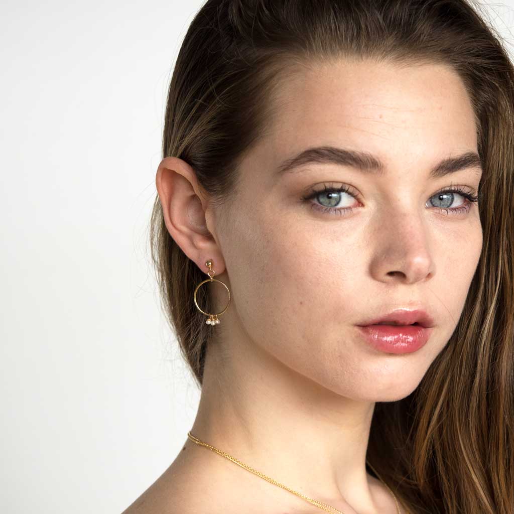 Model wearing Halo Constellation Pearl Earrings Gold