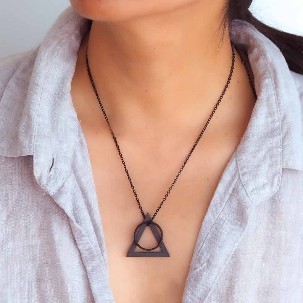 Model wearing Deltaglyph and Ring of Fire Black on linen shirt
