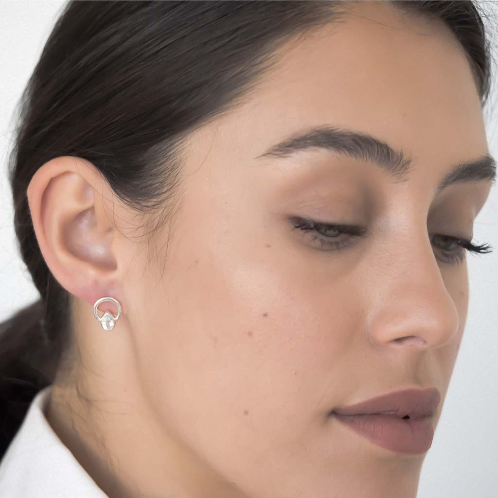Model wearing Teardrop single ray earrings silver aquamarine