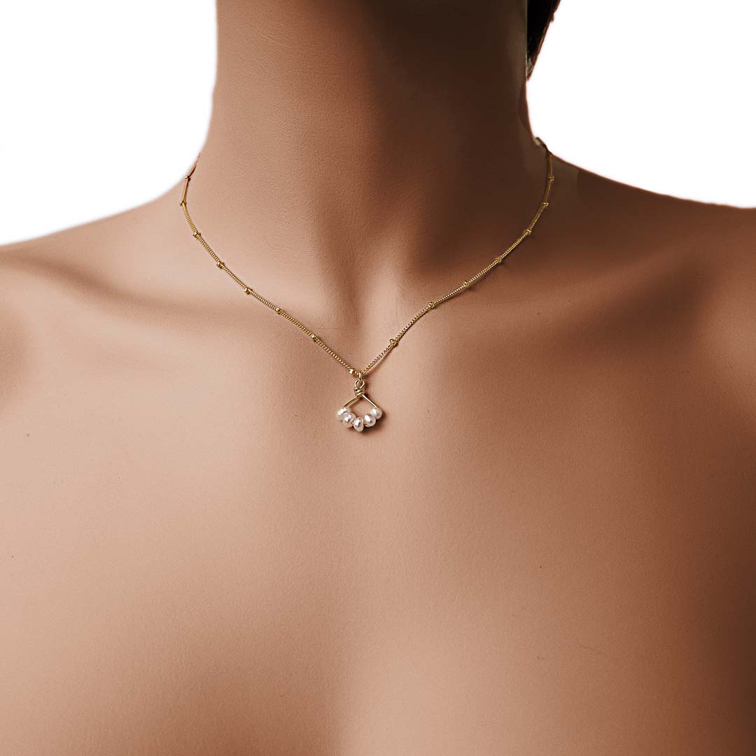 Model wearing Angel 5 14K gold filled necklace with natural pearl gemstones