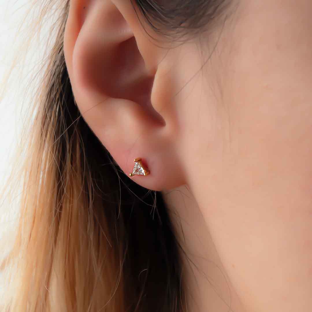 Model wearing Crystal Clear Triangle Stud Earrings - Gold