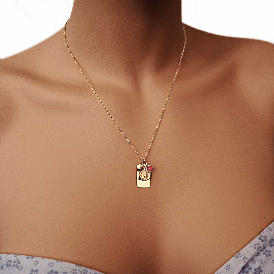 Model wearing Reflections Faith Necklace gold coral
