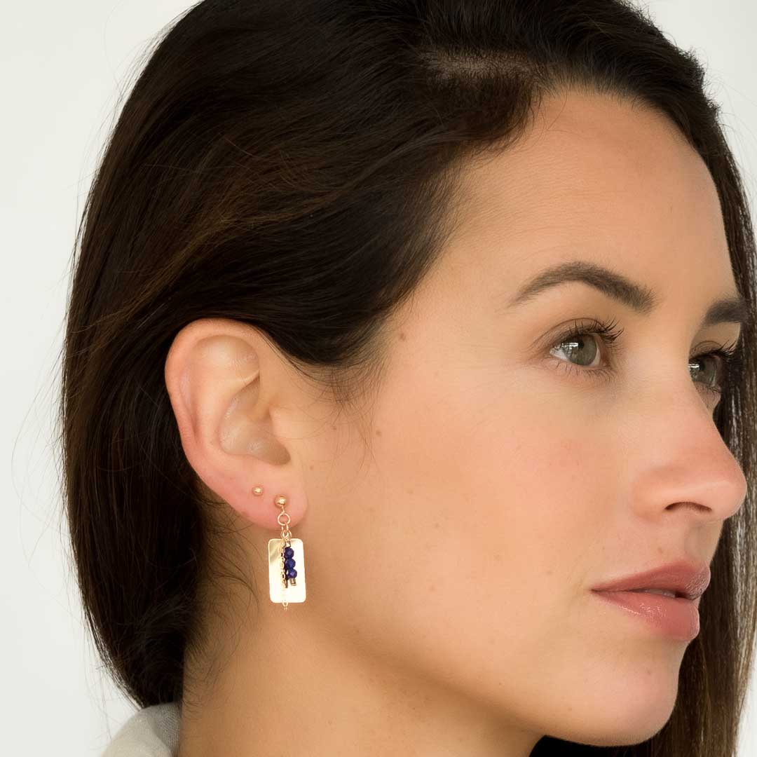 Model wearing Reflections Lapis Lazuli earrings gold and lapis lazuli
