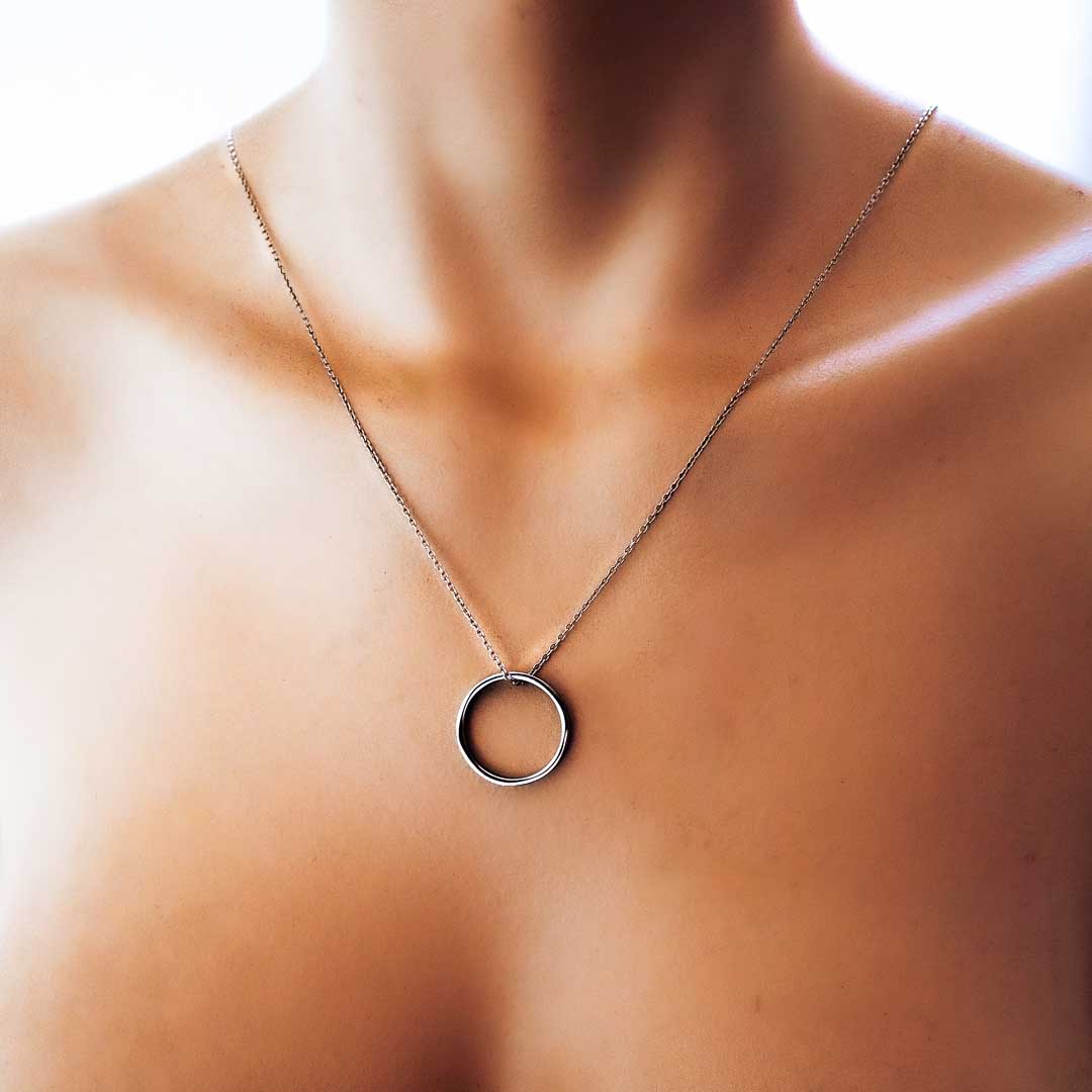 Model wearing ring of fire pendant rhodium short chain