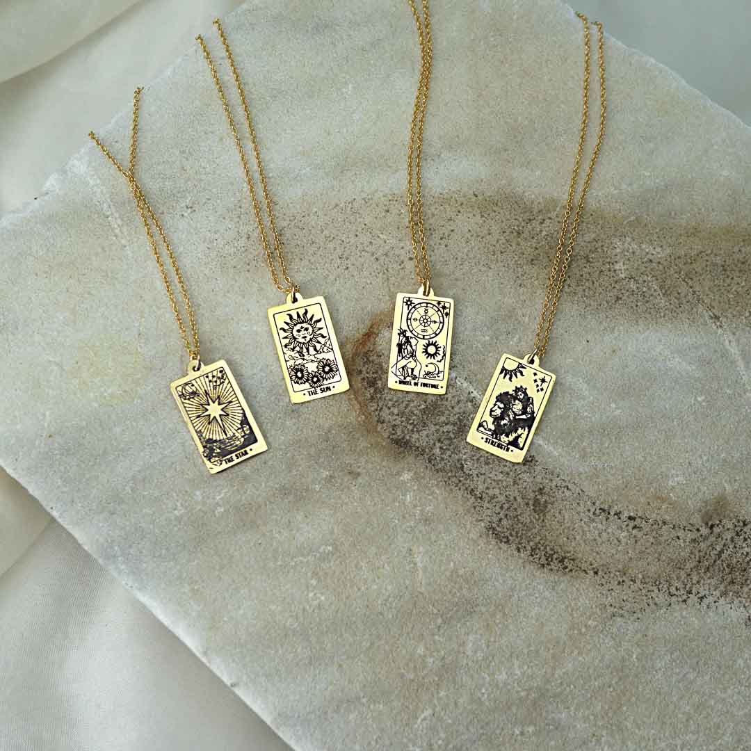 Star, Sun, Wheel of Fortune and Strength Tarot necklace pendants 14K gold filled jewellery flatlay