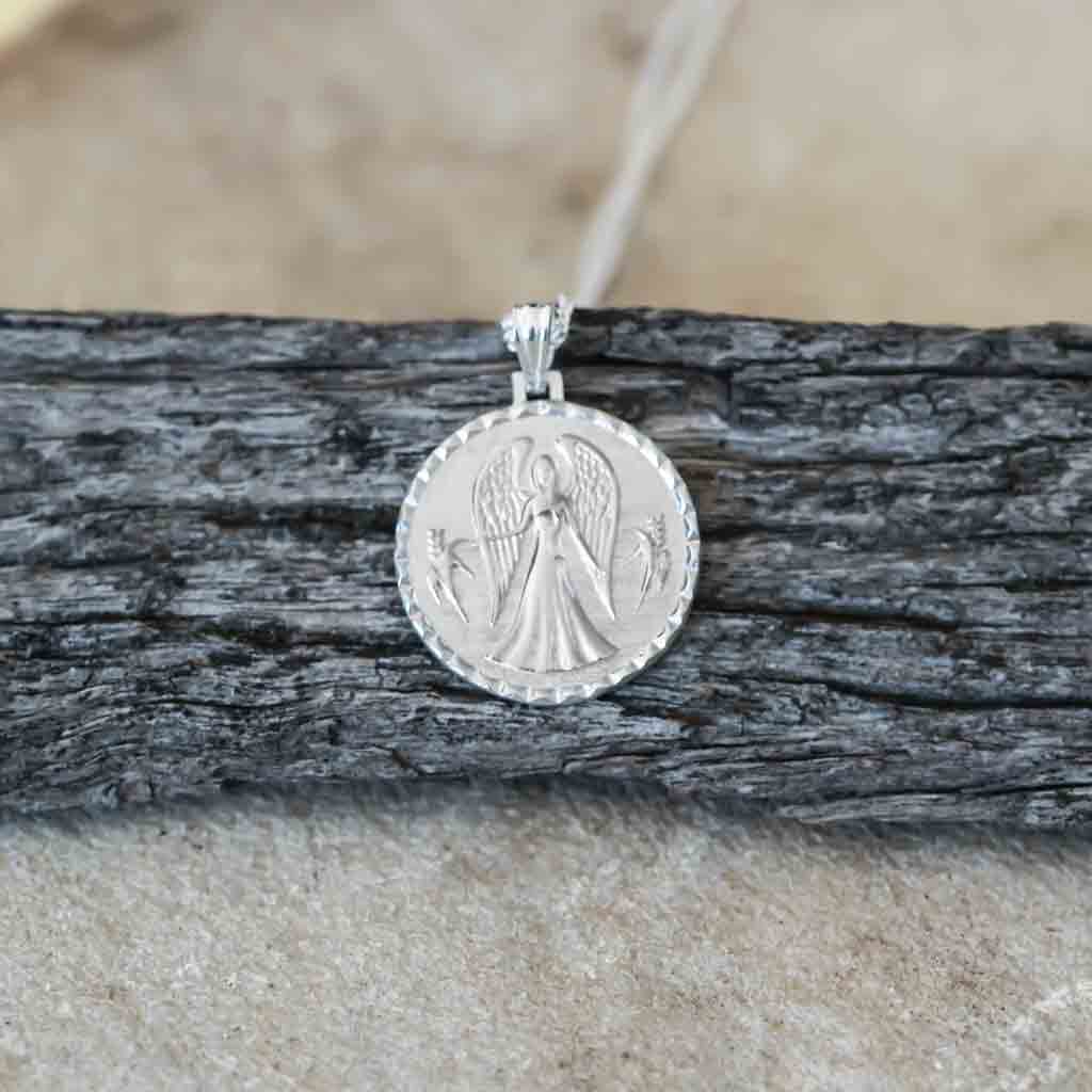 Virgo star sign necklace pendant sterling silver jewellery on wood flatlay