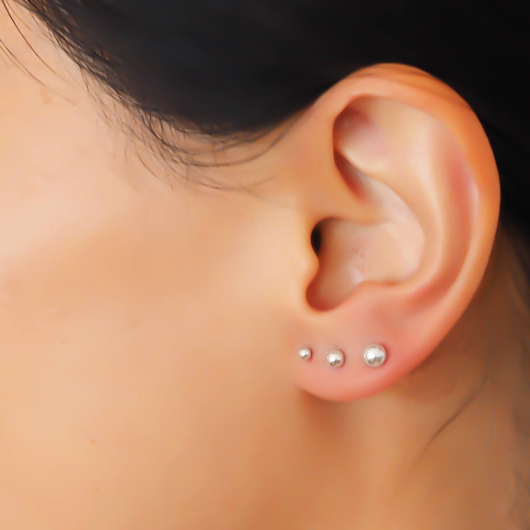 Model ear 3 silver dots close up