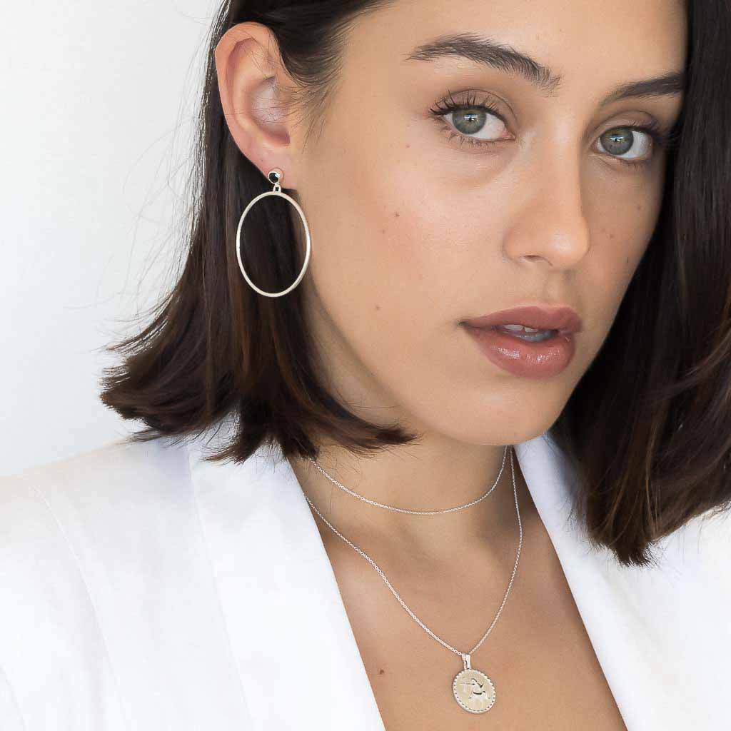 model wearing Circlette Hoop earrings silver and Sagittarius necklace