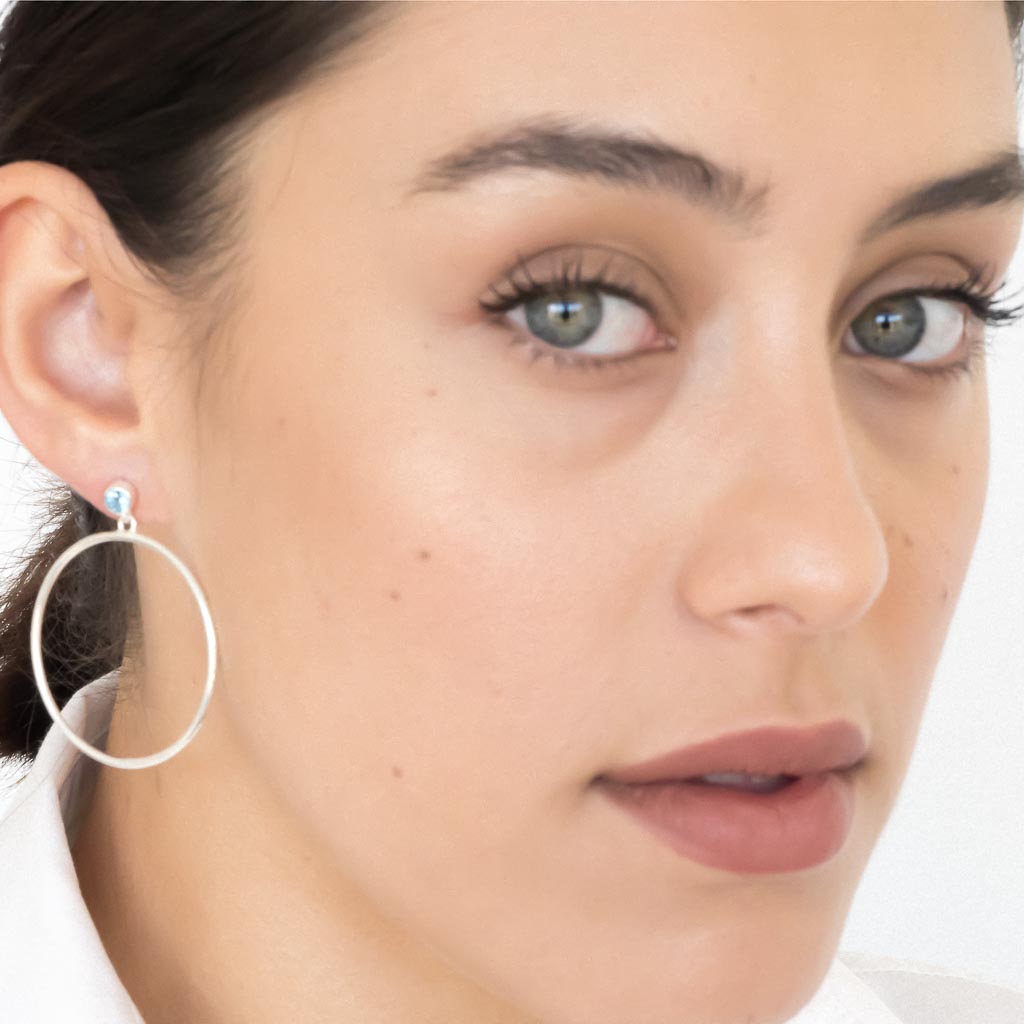 model wearing Circlette Hoop earrings silver swiss blue topaz