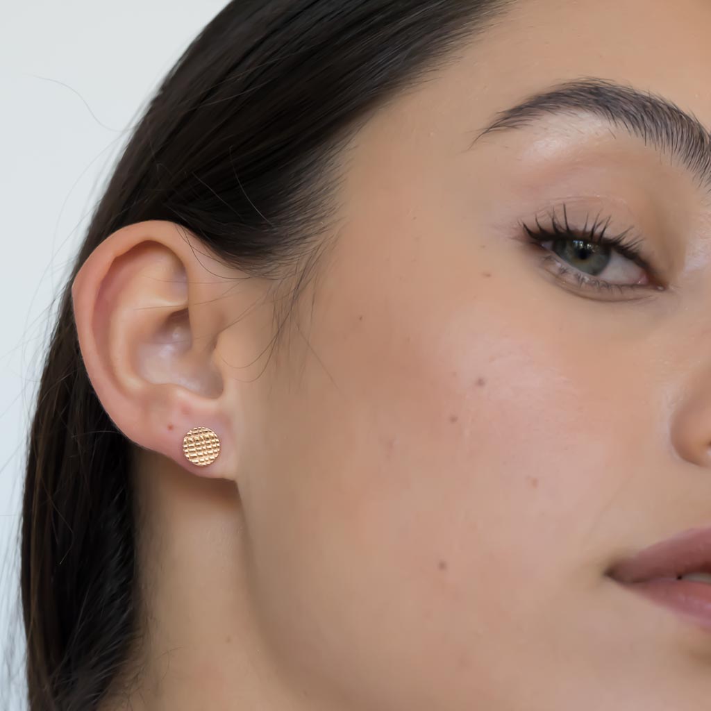 model wearing Rain stud earrings rose gold