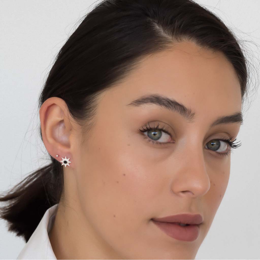 model wearing solstice star earrings silver black spinel