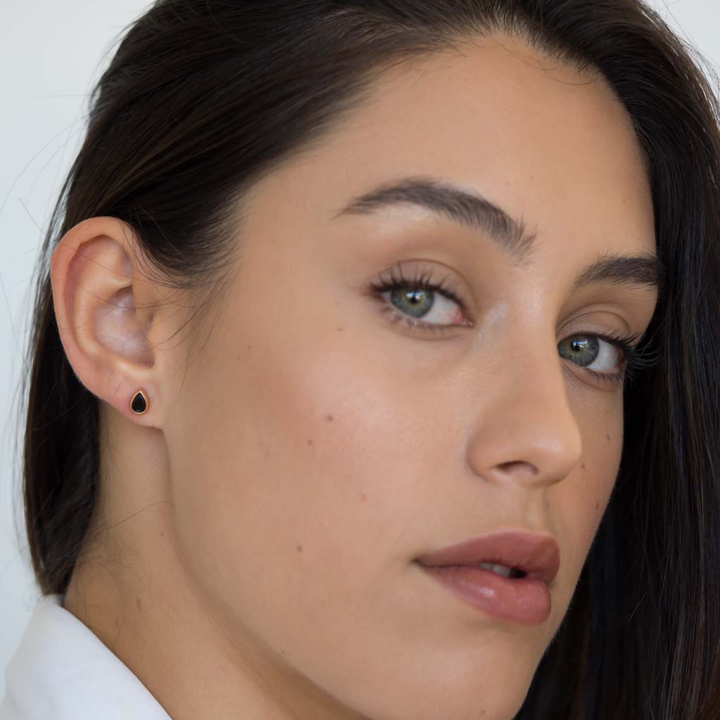 model wearing teardrop stud earrings rose gold black spinel