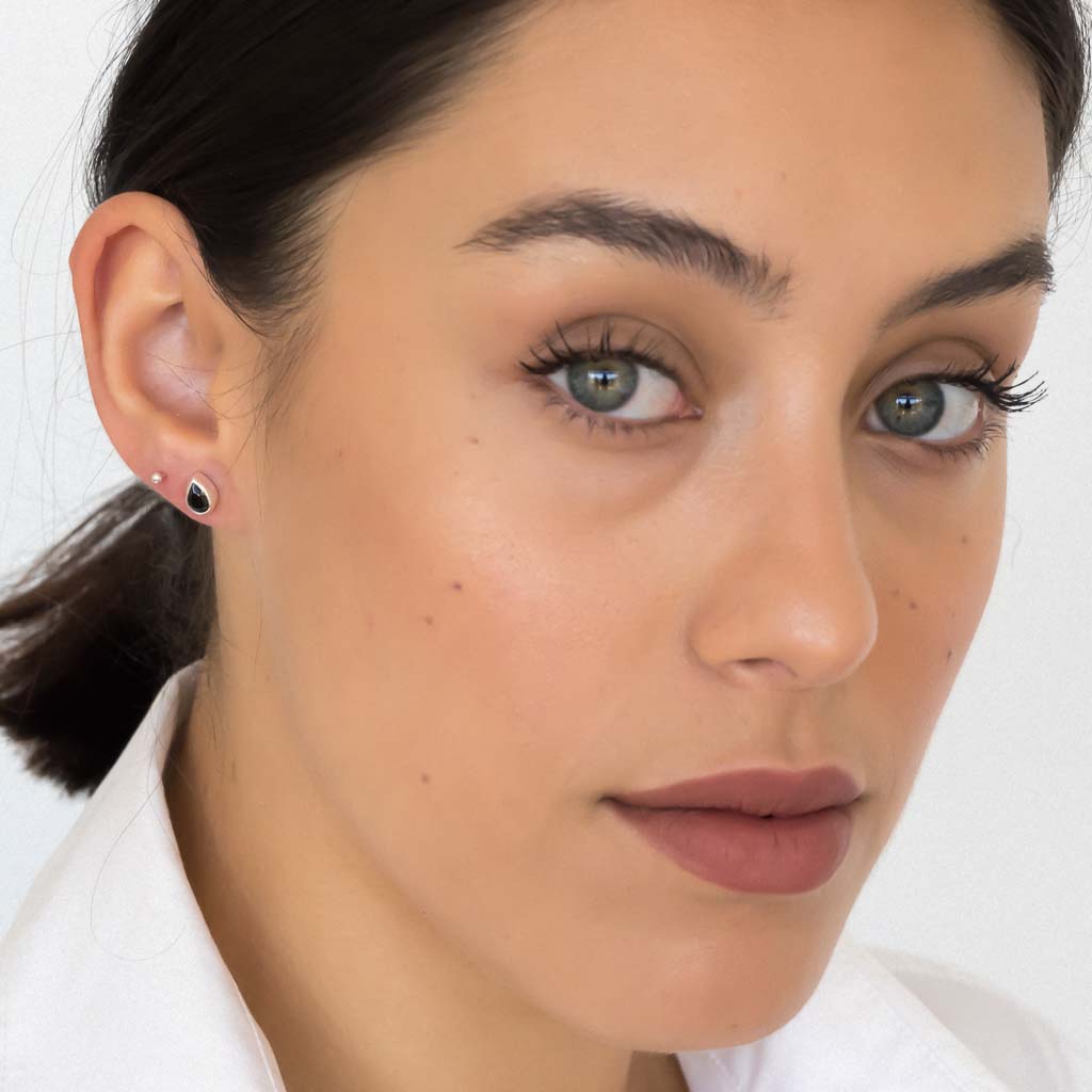 model wearing teardrop stud earrings silver black spinel