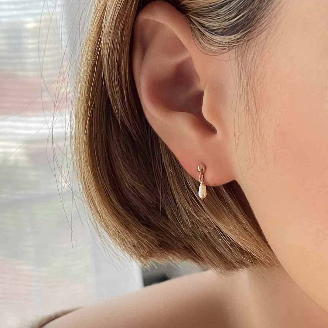 model wearing Lumiere Mini Earrings - Gold and Pearl