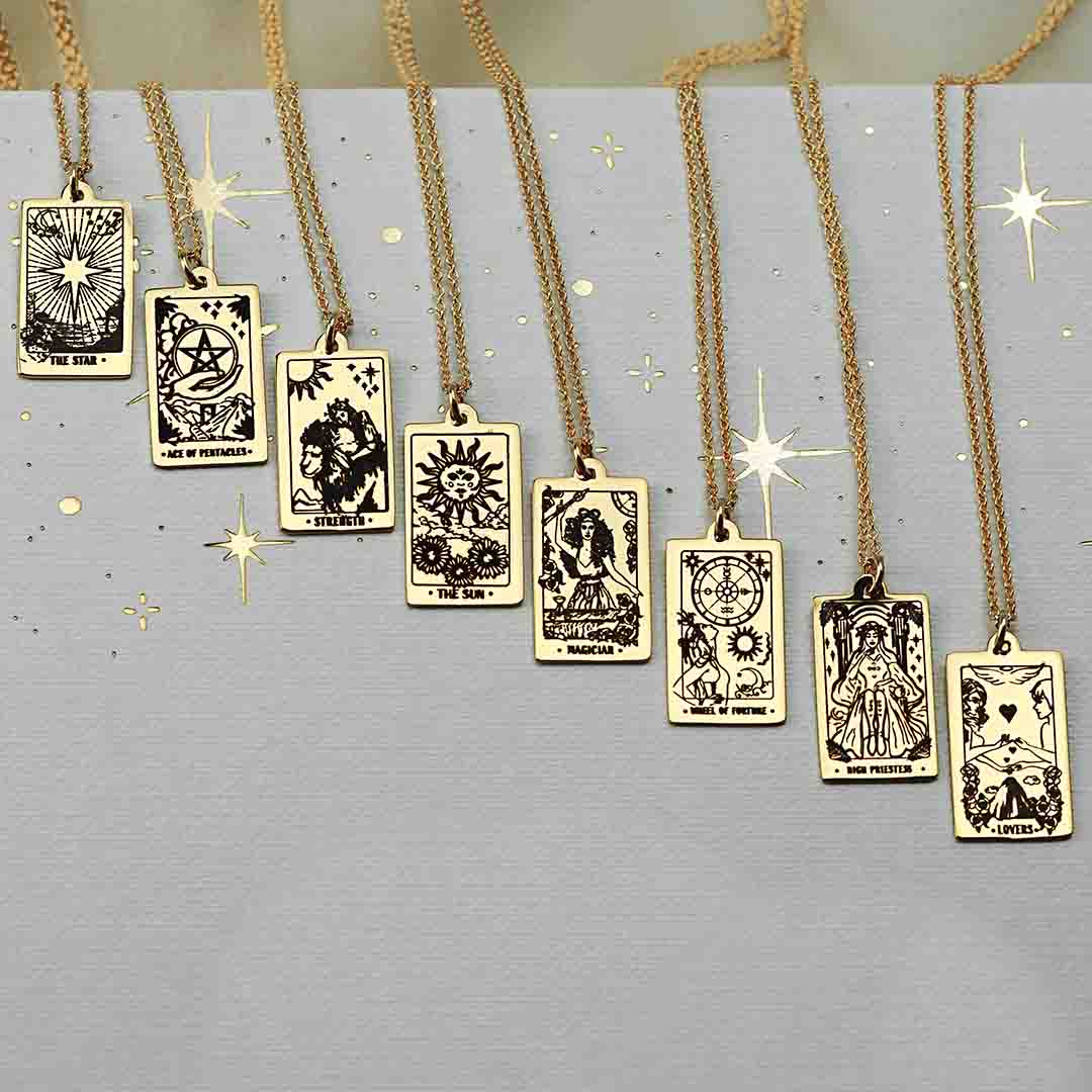 8 gold tarot necklaces on book