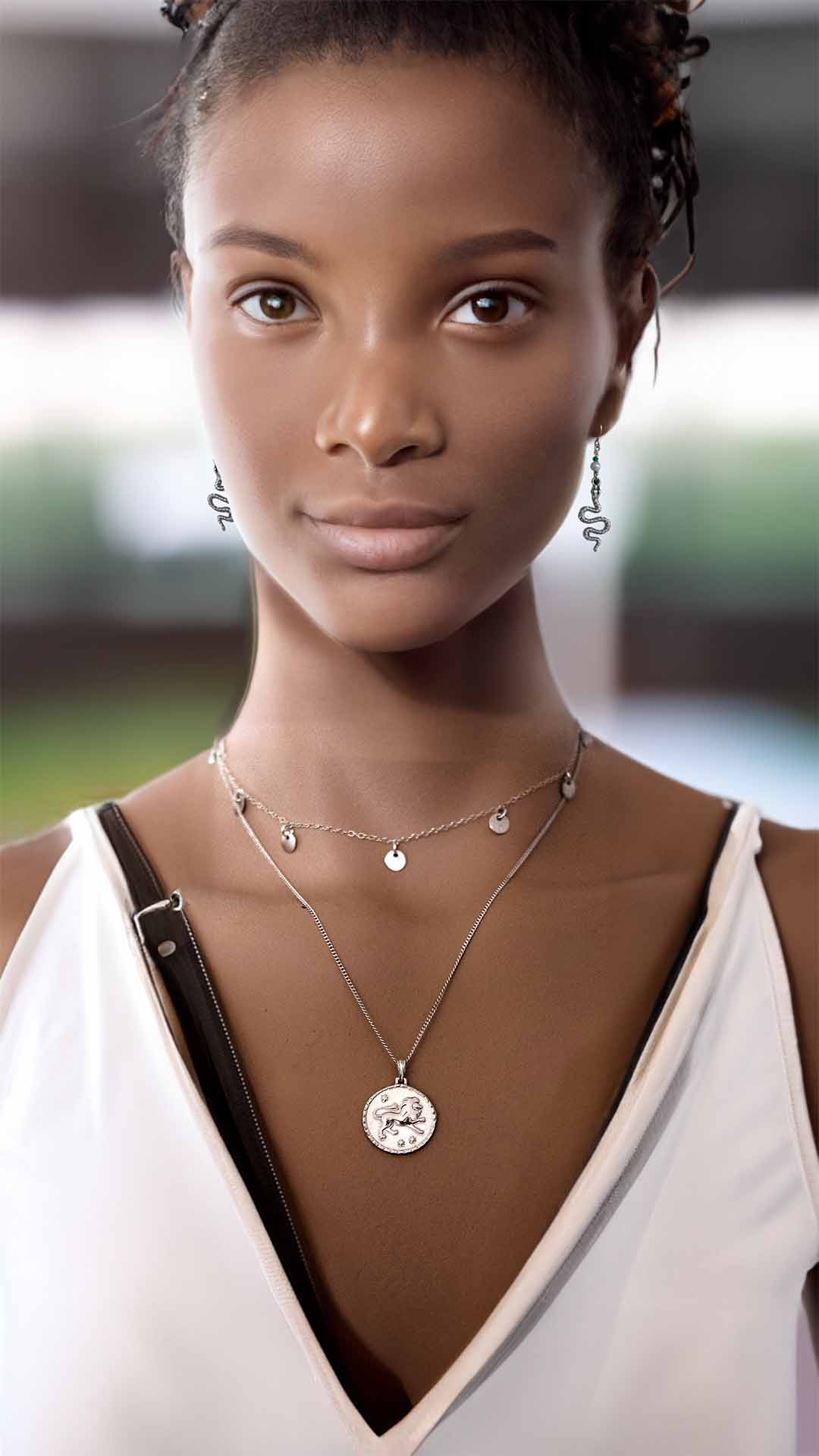 Model wearing leo charmed necklaces silver snake earrings silver cover shot