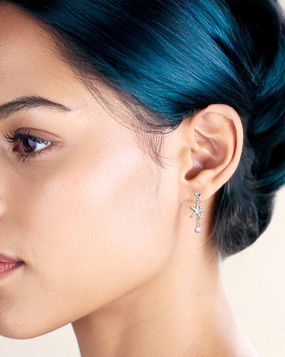 Model wearing Starfish Drop Earrings - Silver and Pearl
