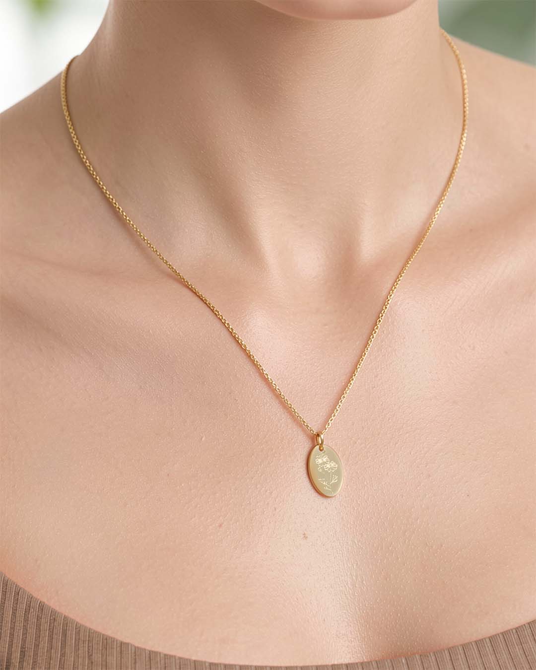 model wearing Brachyscome necklace in gold