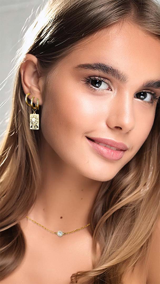 model wearing cahrmed hoops tarot moon earrings stacked single pearl necklace gold