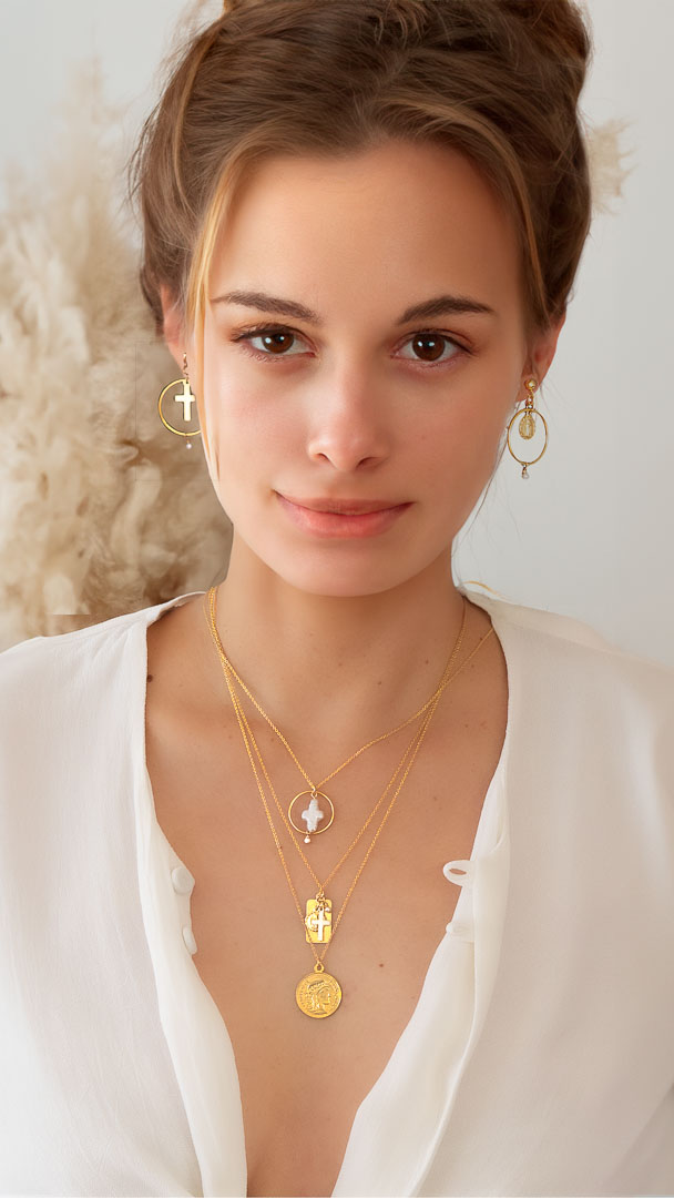 model wearing halo cross reflections coin necklaces faith union earrings gold pearl
