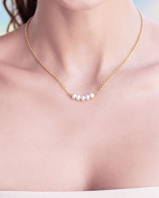 pearl necklace with gold chain 'pebble row' neclace on model , close up chest only, sixD