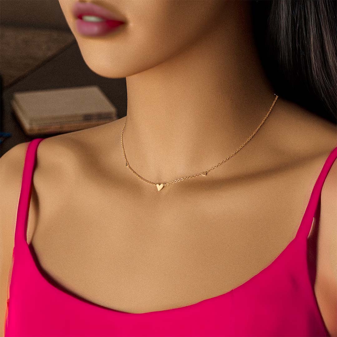 model wearing 3 heart necklace gold