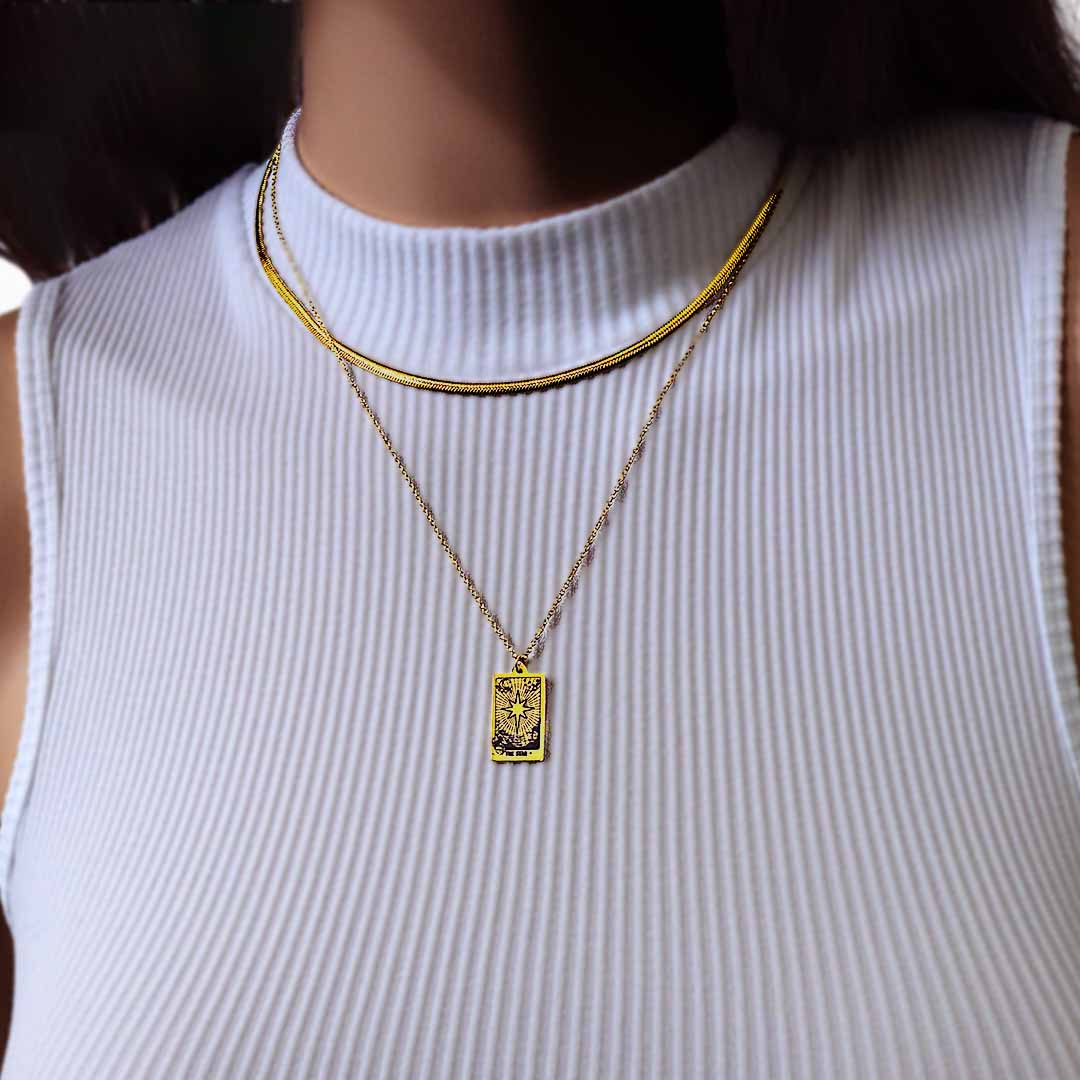 model wearing baby medusa tarot star necklaces gold layered
