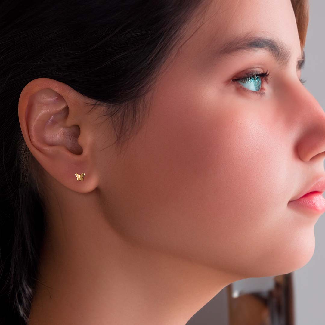 model wearing Butterfly Stud Earrings - Gold