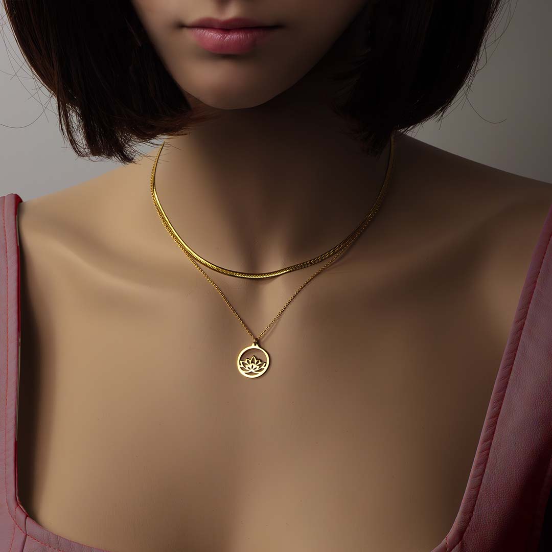 model wearing baby medusa baby lotus necklaces gold layered