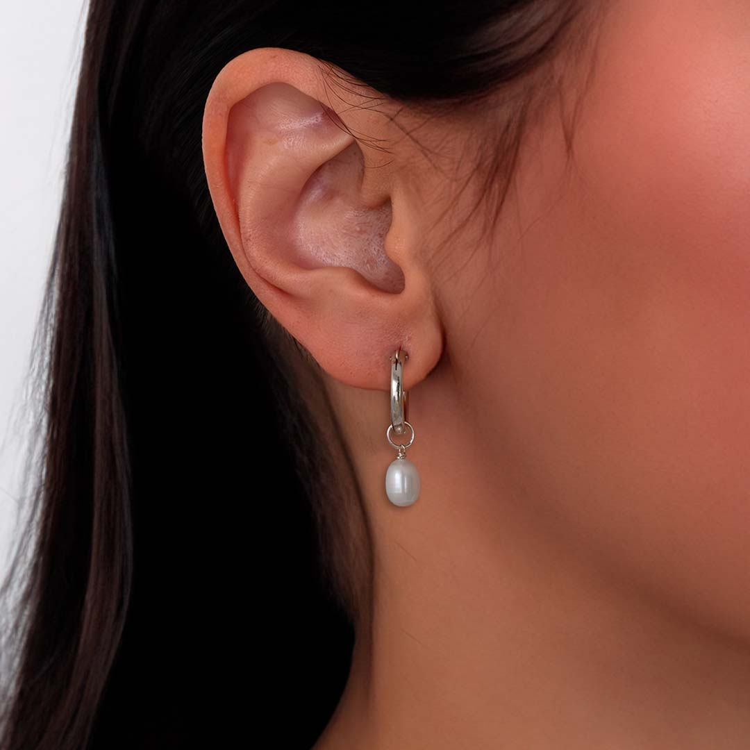model wearing pearl charmed hoop earrings silver