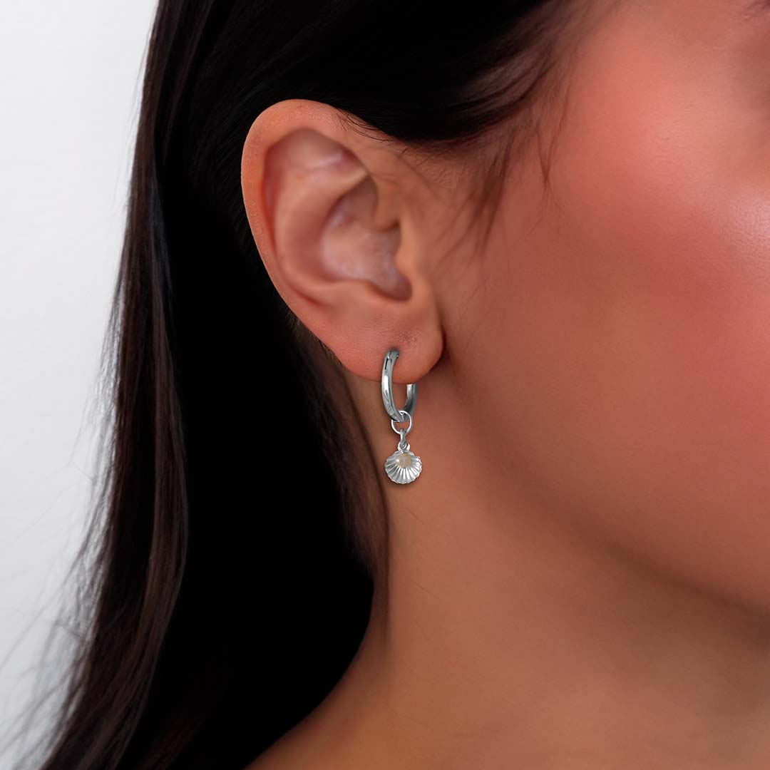 model wearing seashell charmed hoop earrings silver pearl