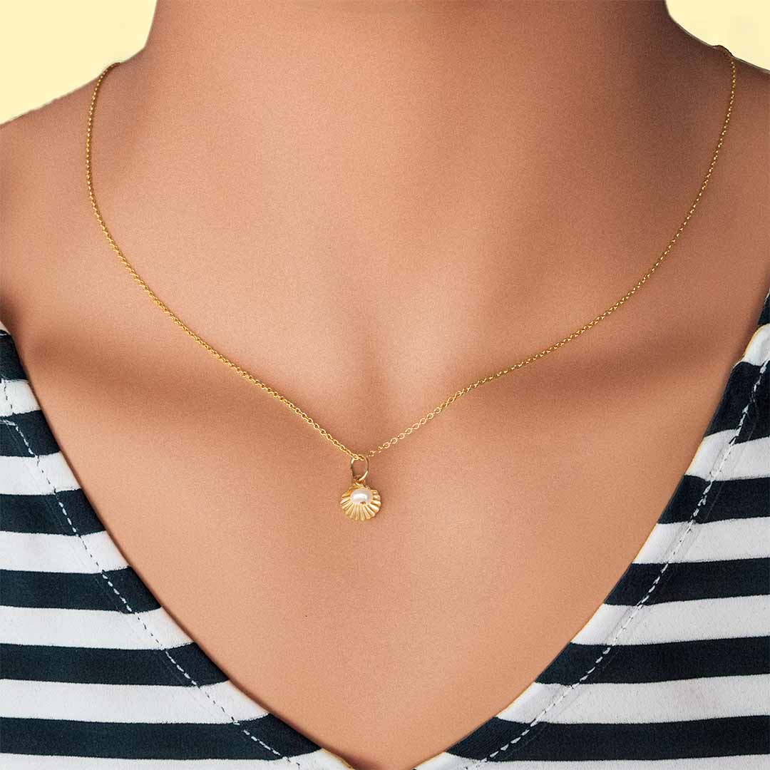 Model wearing Shell Pod Necklace - Gold and Pearl