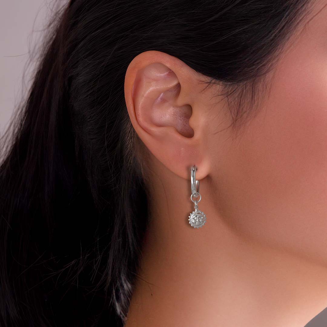 model wearing sun charmed hoop earrings silver
